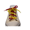 a white sneaker with a braided shoelace dyed red and yellow