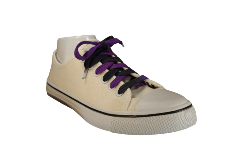 Black and purple shoelaces in a white shoe