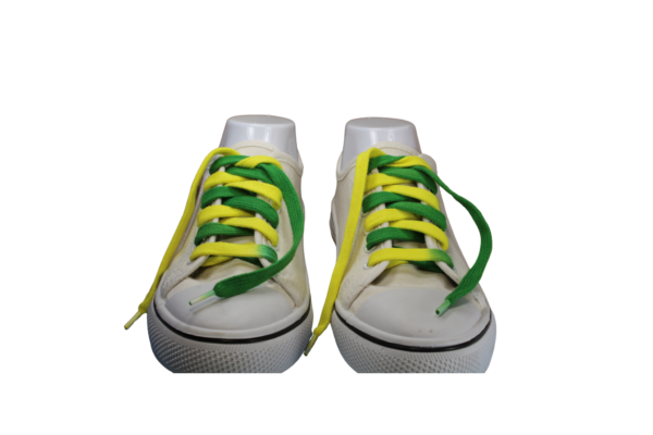a pair of flat shoelaces that are green on one side yellow on the other