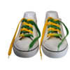 a pair of untied flat custom made green and gold shoelaces