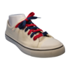 navy blue and red flat shoelace in a white shoe at an angle