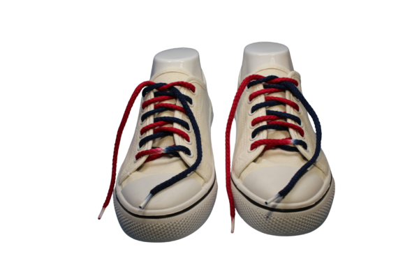 a pair of white sneakers with custom dyed navy blue and red braided untied shoelaces