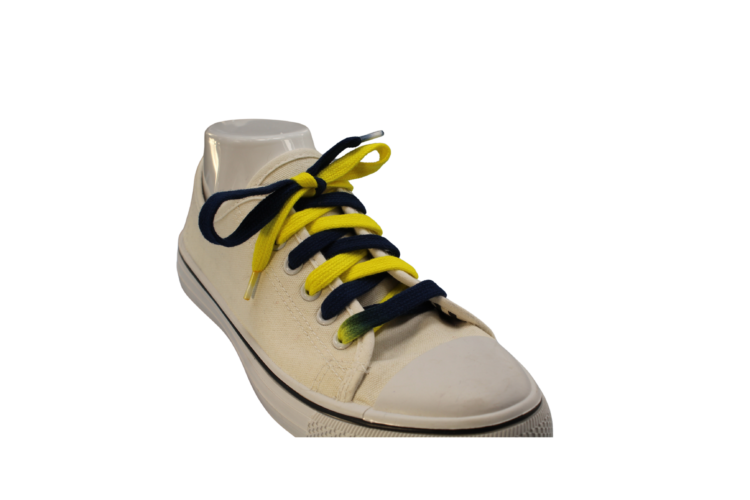 Navy Blue and Yellow shoelaces at an angle in a white tennis shoe