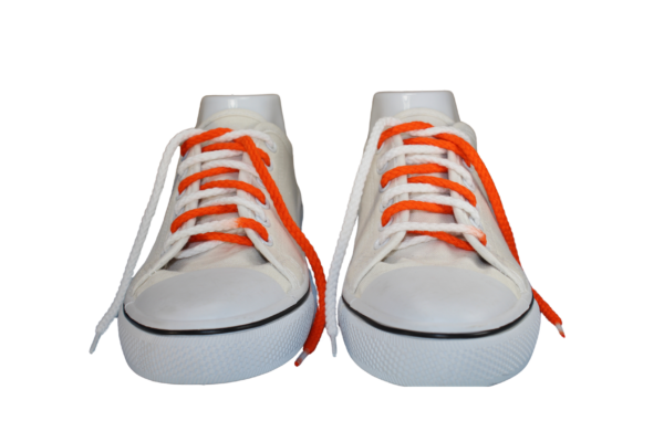 A pair of orange and white braided shoelaces in a white shoe
