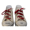 a shoe with a braided red and white shoelace and a different shoe with a flat shoelace of red and white